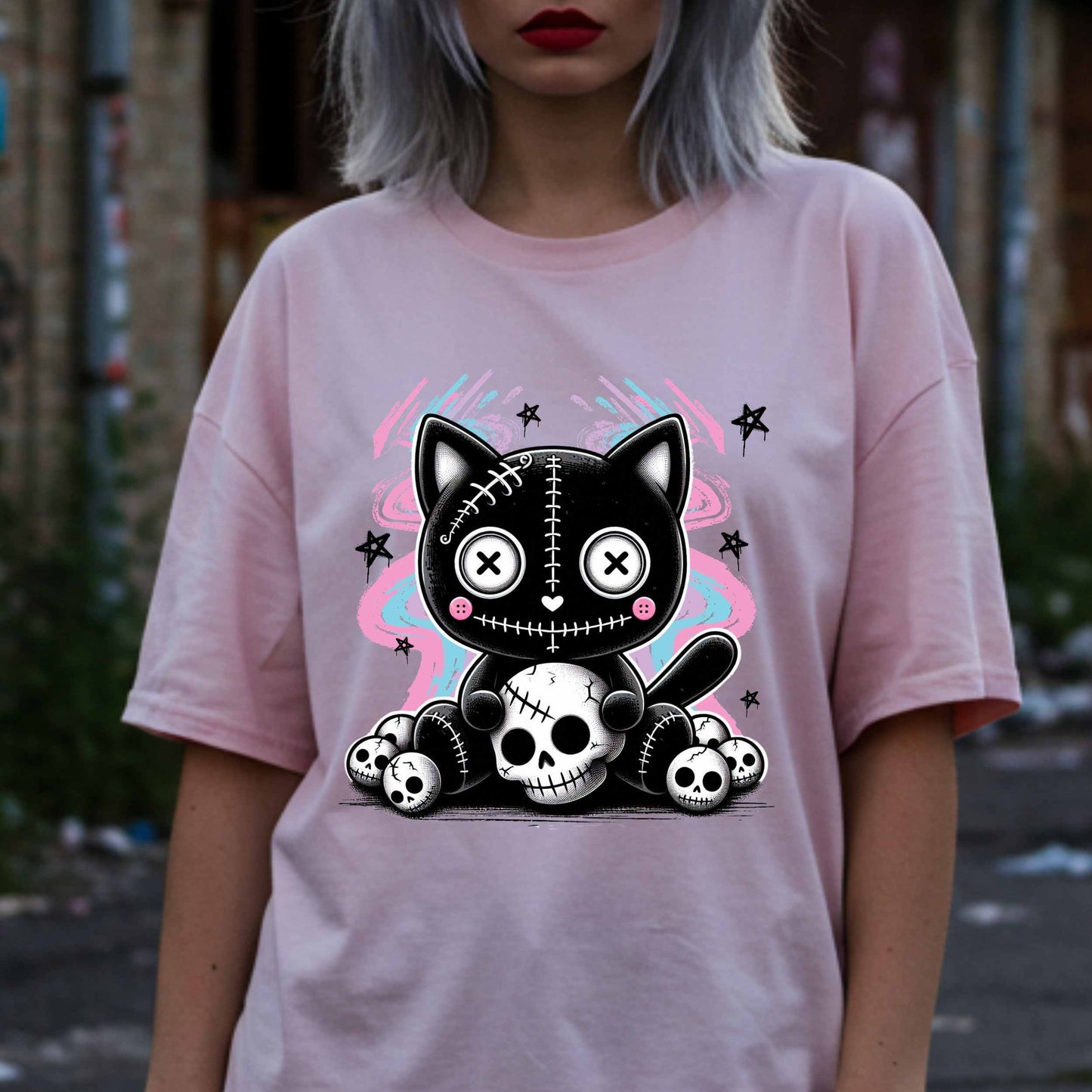 This pastel goth cat Halloween shirt is what happens when adorable meets unhinged. Featuring a stitched-up button-eyed kitten chillin’ on a throne of skulls like it's just another Tuesday, this tee is made for the spooky soul with a soft side (and a slightly murderous glare). Wear it to haunt the streets or just vibe in your villain era—either way, it’s a look. 