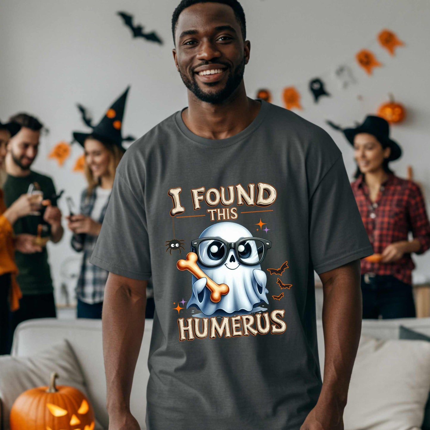 Bone-afide hilarious. This “I Found This Humerus” tee is the ultimate Halloween dad joke wrapped in spooky cute style. Featuring a ghost rocking nerdy glasses and proudly holding a humerus bone like it just cracked itself up—because it did.