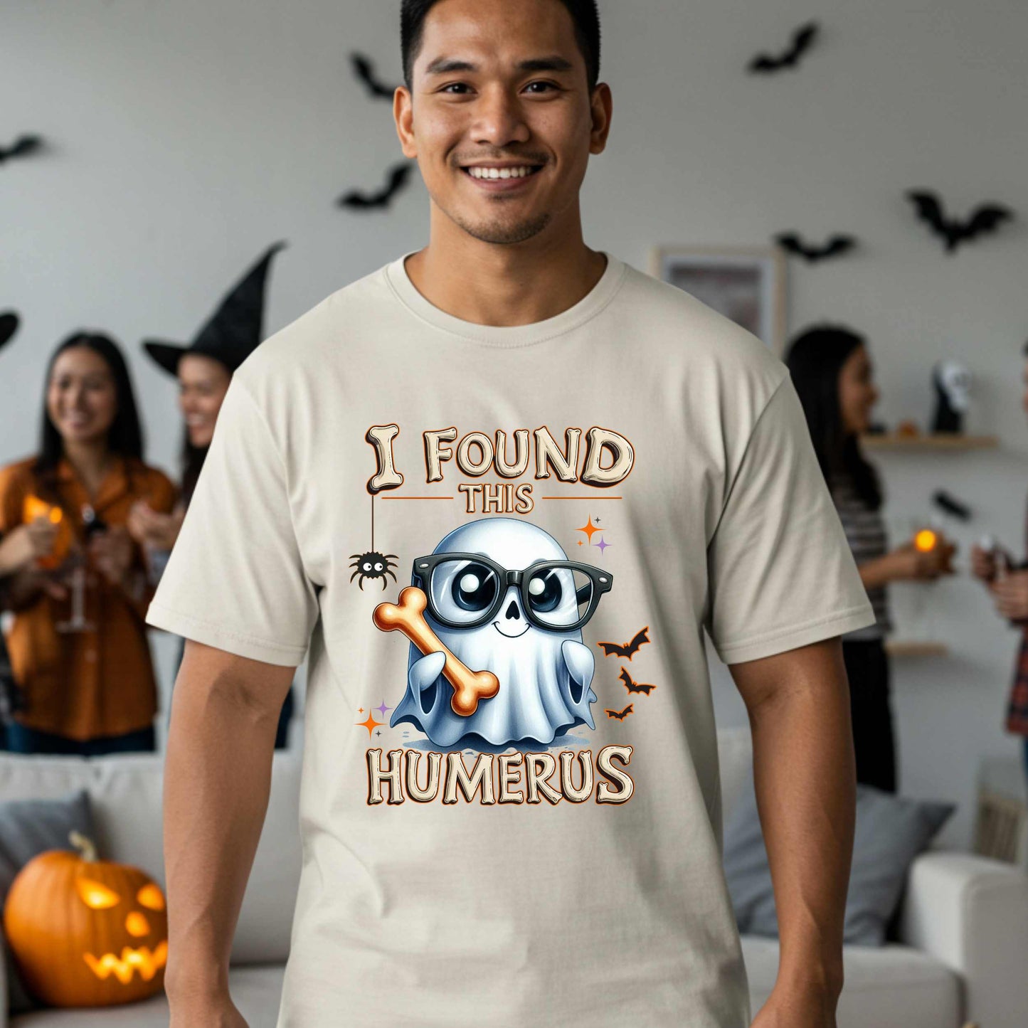 Bone-afide hilarious. This “I Found This Humerus” tee is the ultimate Halloween dad joke wrapped in spooky cute style. Featuring a ghost rocking nerdy glasses and proudly holding a humerus bone like it just cracked itself up—because it did.