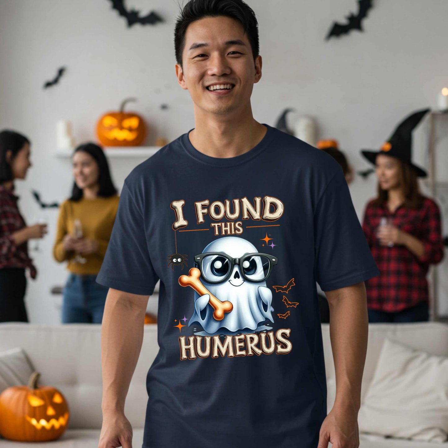 Bone-afide hilarious. This “I Found This Humerus” tee is the ultimate Halloween dad joke wrapped in spooky cute style. Featuring a ghost rocking nerdy glasses and proudly holding a humerus bone like it just cracked itself up—because it did.