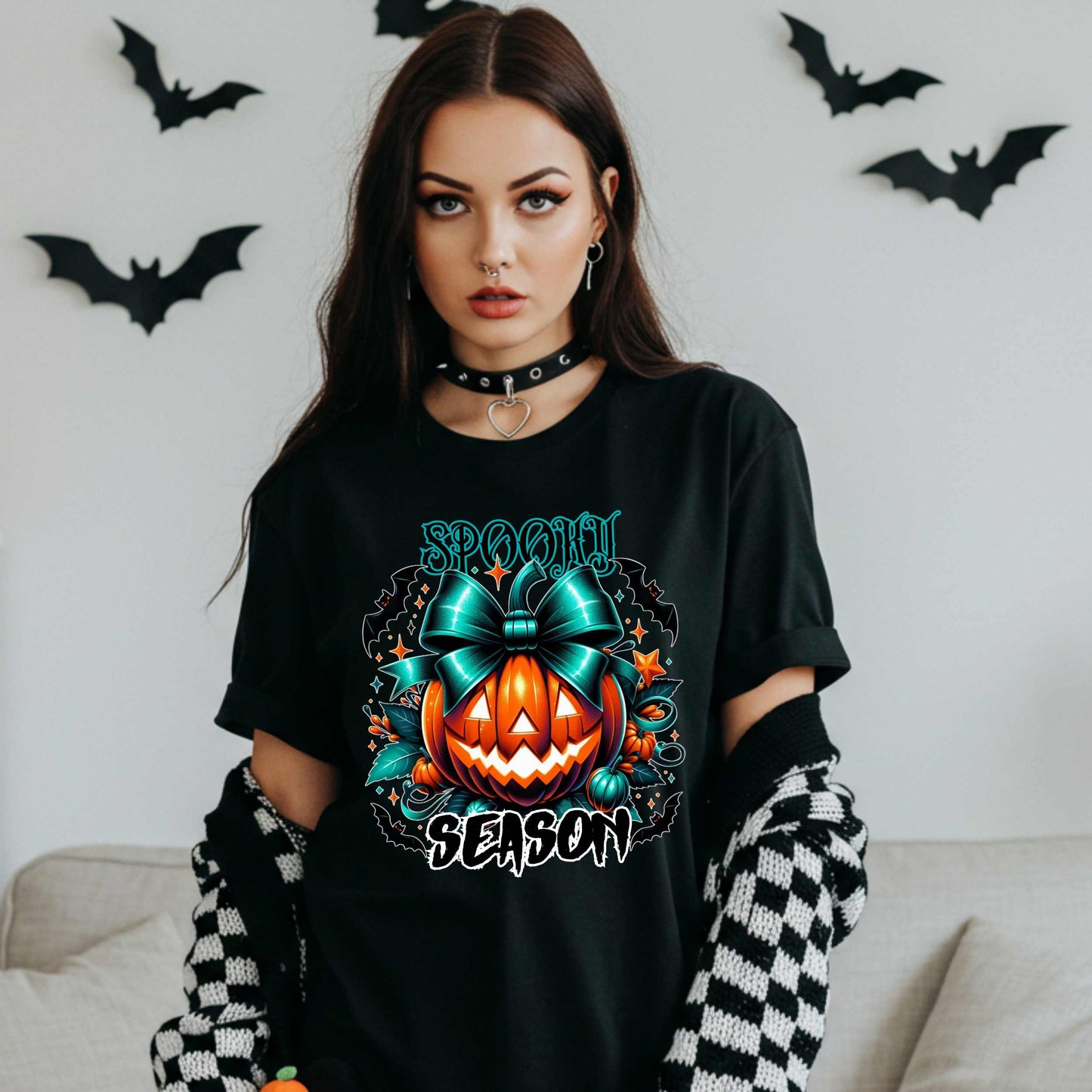 Step aside basic witches, this pumpkin came to SLAY. Our Spooky Season tee brings the perfect mix of creepy and cute—featuring a fierce jack-o’-lantern crowned with a bold teal bow and surrounded by gothic glam accents.