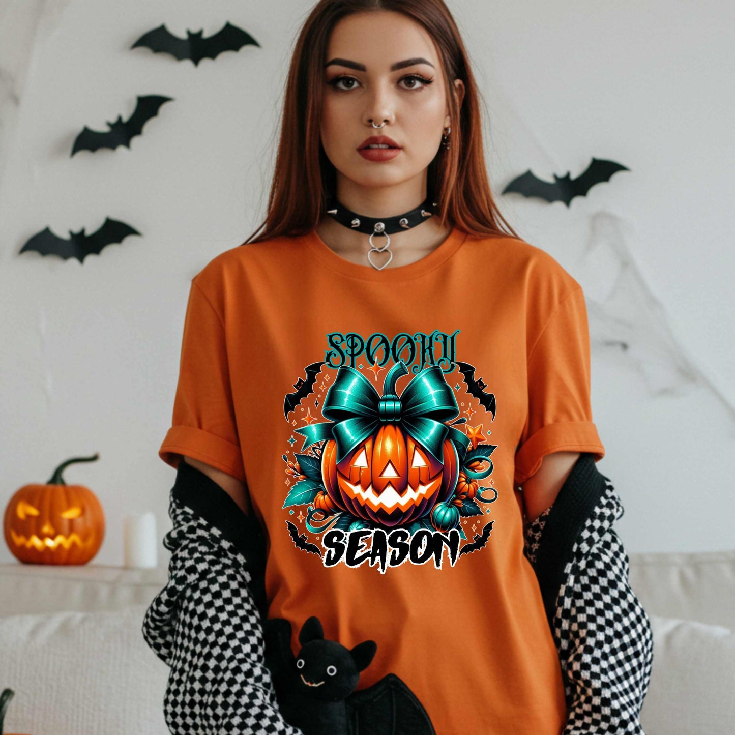 Step aside basic witches, this pumpkin came to SLAY. Our Spooky Season tee brings the perfect mix of creepy and cute—featuring a fierce jack-o’-lantern crowned with a bold teal bow and surrounded by gothic glam accents.