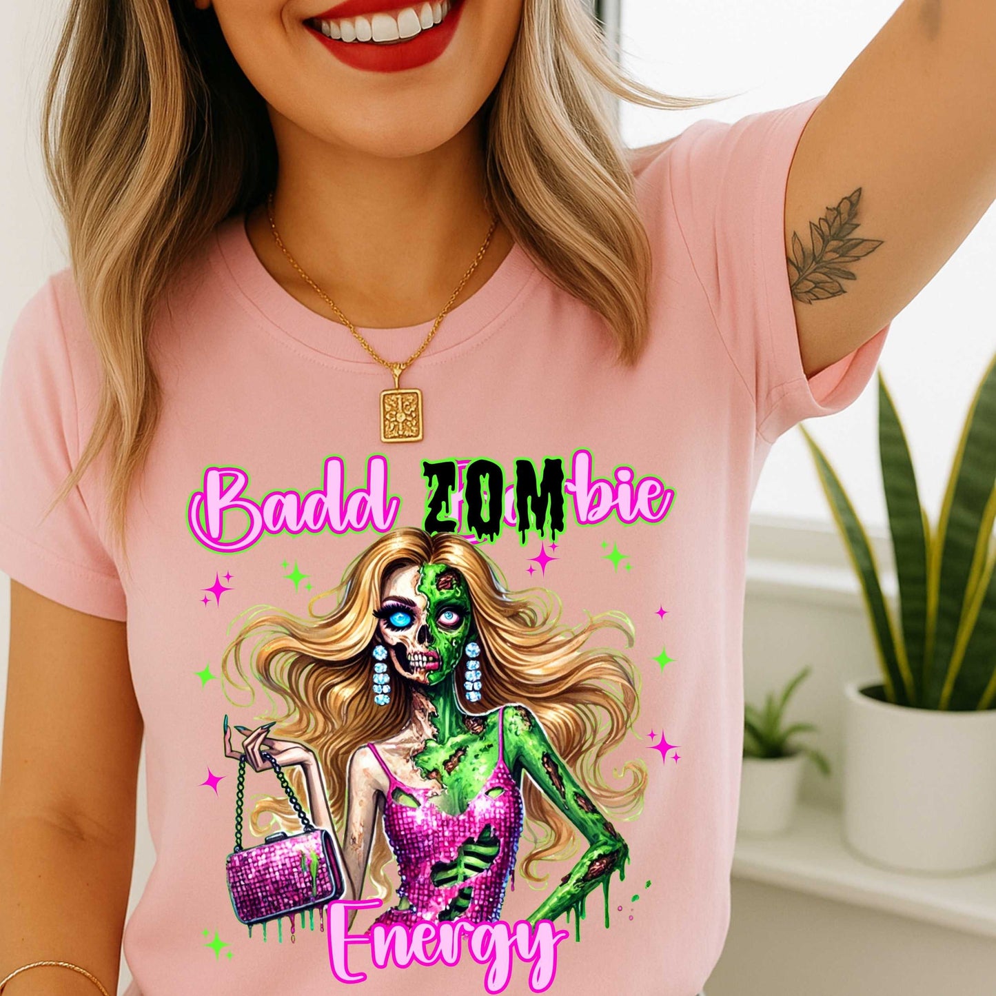 Brains, but make it fashion. This Badd Zombie Energy tee is for the girls who slay… even in the afterlife. Rocking a glittery pink dress, designer handbag, and enough undead glam to raise the dead, this zombie babe is dripping in sass (and maybe a little ooze).