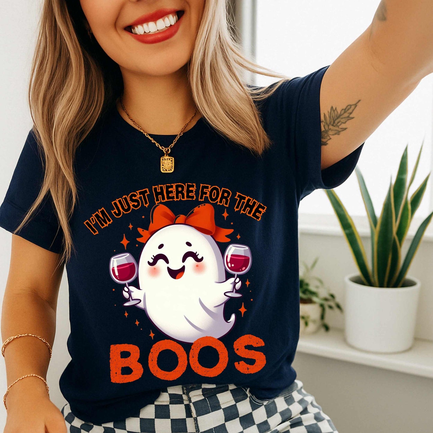 This hilarious “I’m Just Here for the Boos” tee features a bubbly little ghost with a bow, two glasses of red in hand, and zero shame in her sip game. She’s classy, a little sassy, and probably on her third pour. Perfect for Halloween parties, girls’ nights, wine tastings, or just pretending your spooky spirit isn’t fueled entirely by cabernet.