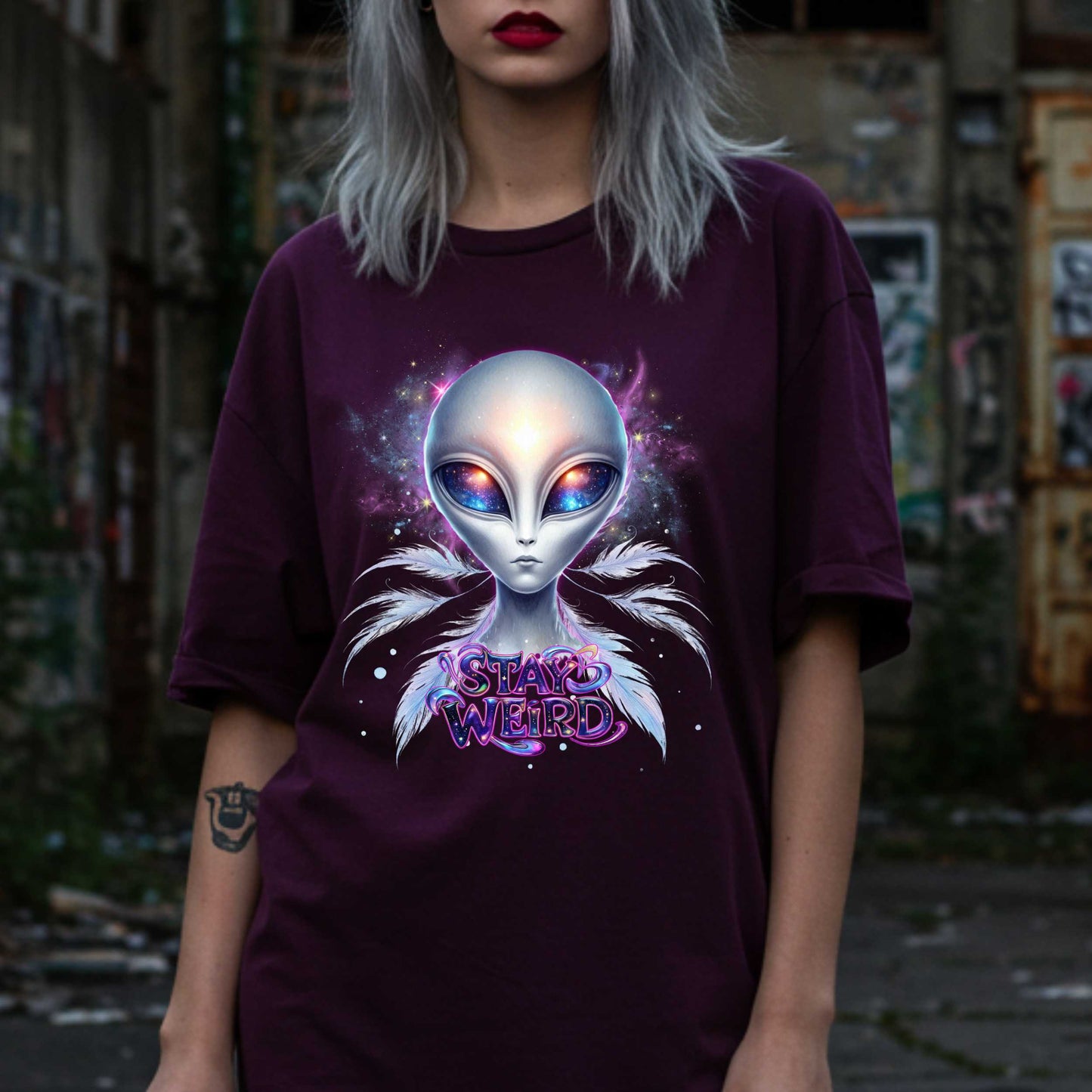 Channel your inner cosmic weirdo with this bold Alien Stay Weird graphic tee. Designed for the unapologetically different, this spacey shirt features an ethereal extraterrestrial with galaxy eyes and major interdimensional energy. 