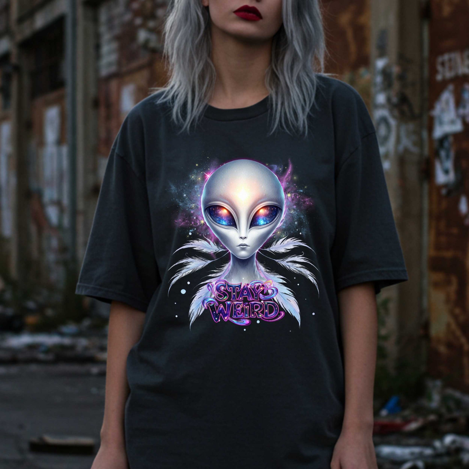 Channel your inner cosmic weirdo with this bold Alien Stay Weird graphic tee. Designed for the unapologetically different, this spacey shirt features an ethereal extraterrestrial with galaxy eyes and major interdimensional energy. 