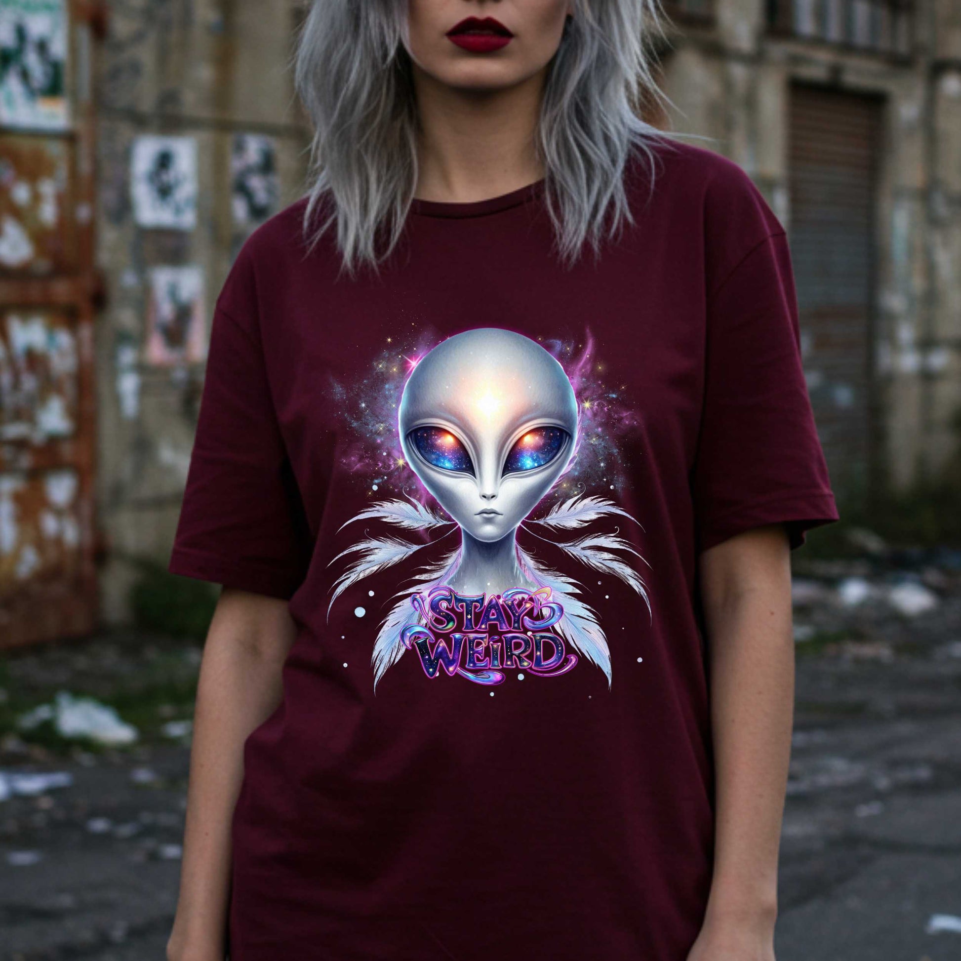 Channel your inner cosmic weirdo with this bold Alien Stay Weird graphic tee. Designed for the unapologetically different, this spacey shirt features an ethereal extraterrestrial with galaxy eyes and major interdimensional energy. 