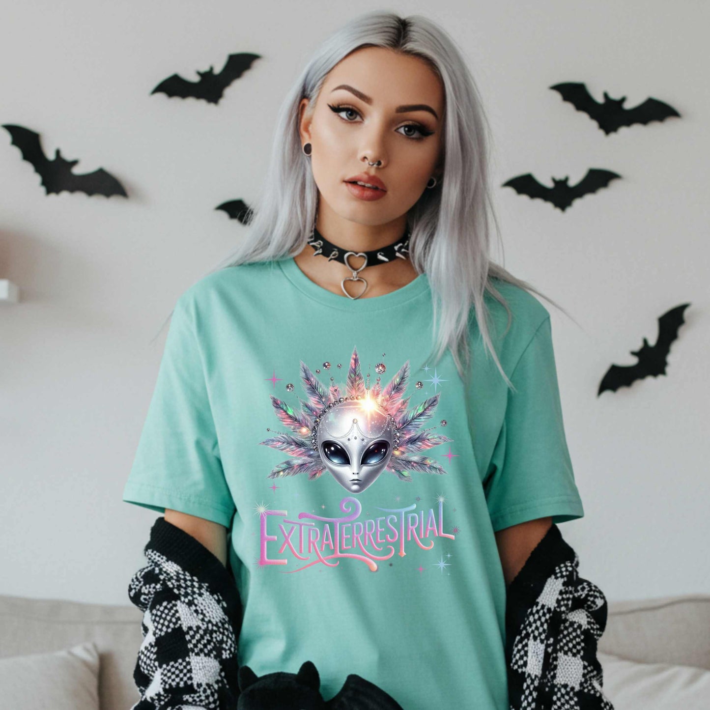 Calling all celestial divas—this Extraterrestrial alien graphic tee is giving big space energy and intergalactic glam. Featuring a radiant alien queen with jeweled head bling, pastel feathers, and more attitude than a Mercury in retrograde meltdown, this shirt is perfect for Halloween, sci-fi fans, and anyone who knows they weren’t meant for Earth’s nonsense. 