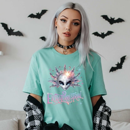 Calling all celestial divas—this Extraterrestrial alien graphic tee is giving big space energy and intergalactic glam. Featuring a radiant alien queen with jeweled head bling, pastel feathers, and more attitude than a Mercury in retrograde meltdown, this shirt is perfect for Halloween, sci-fi fans, and anyone who knows they weren’t meant for Earth’s nonsense. 
