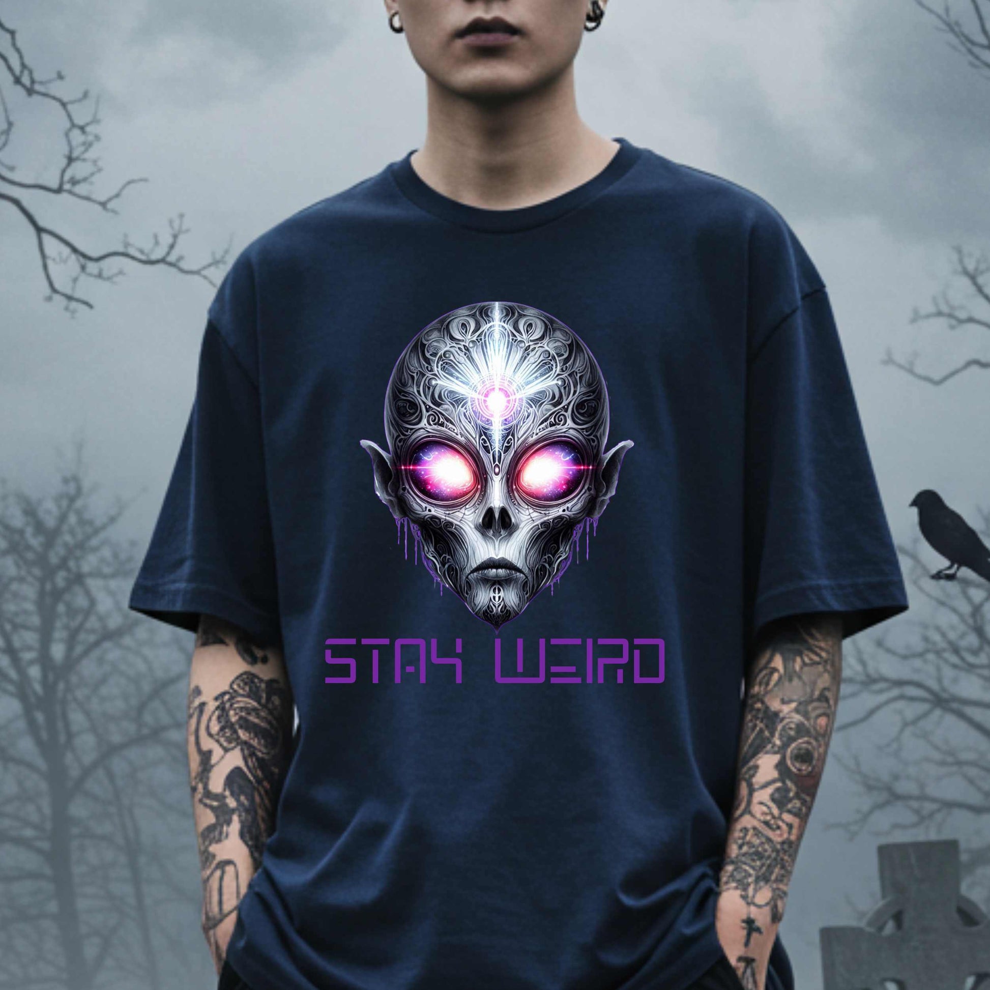 This Stay Weird alien shirt is for the cosmic misfits, the night-dwellers, and the ones who don’t just embrace their weirdness—they glorify it. Featuring a hauntingly detailed alien face with glowing eyes and third-eye vibes, this tee is equal parts spooky, surreal, and unapologetically bold.