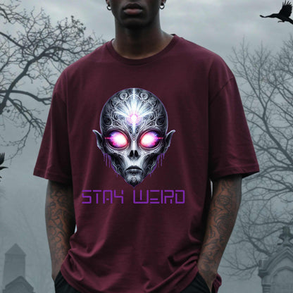 This Stay Weird alien shirt is for the cosmic misfits, the night-dwellers, and the ones who don’t just embrace their weirdness—they glorify it. Featuring a hauntingly detailed alien face with glowing eyes and third-eye vibes, this tee is equal parts spooky, surreal, and unapologetically bold.