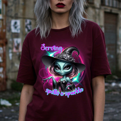 Serving intergalactic glam with a side of sparkle and sass! This glam alien witch graphic tee is perfect for the spooky season and every day you feel too fabulous for Earth. Featuring a fierce extraterrestrial baddie in full witchy slay mode, this shirt says, “I cast spells, but I do it in highlighter and heels.”