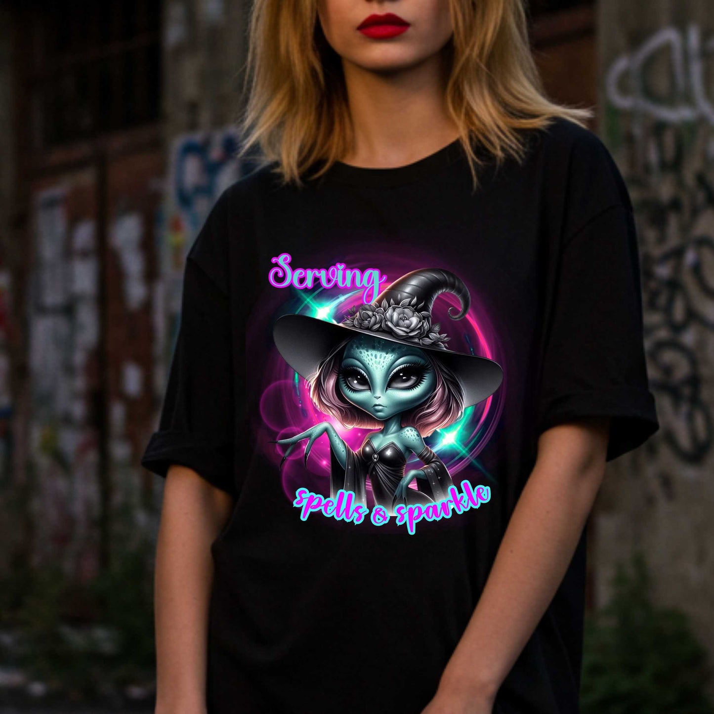 Serving intergalactic glam with a side of sparkle and sass! This glam alien witch graphic tee is perfect for the spooky season and every day you feel too fabulous for Earth. Featuring a fierce extraterrestrial baddie in full witchy slay mode, this shirt says, “I cast spells, but I do it in highlighter and heels.”