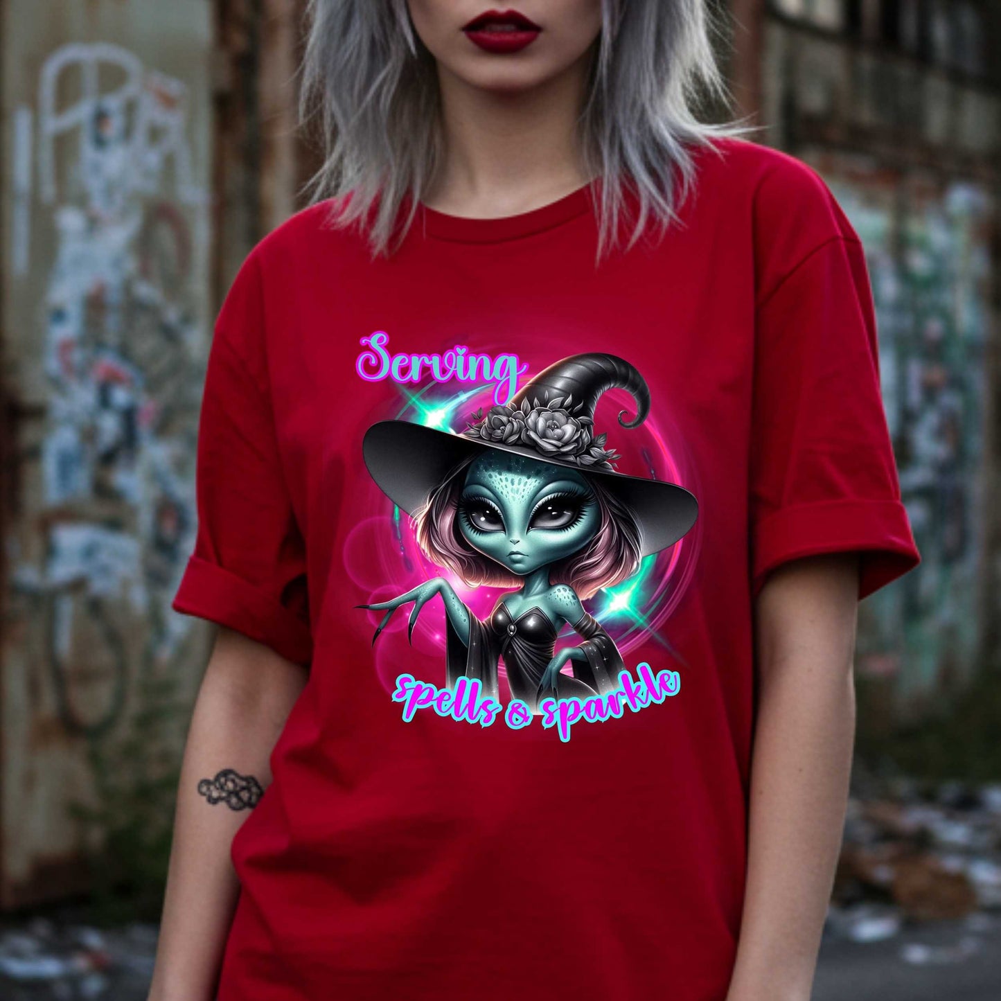 Serving intergalactic glam with a side of sparkle and sass! This glam alien witch graphic tee is perfect for the spooky season and every day you feel too fabulous for Earth. Featuring a fierce extraterrestrial baddie in full witchy slay mode, this shirt says, “I cast spells, but I do it in highlighter and heels.”