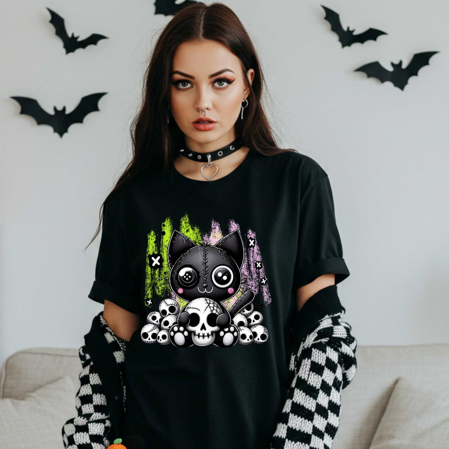 Pastel goth cat Halloween shirt for the spooky babe who wants to be cute, creepy, and slightly unbothered by your opinions. This little stitched-up kitten is sittin’ pretty on a pile of skulls, looking like she just clawed her way out of a haunted Lisa Frank binder. It’s soft, spooky, and a little sinister—just like your mood in October (and let’s be honest, year-round).&nbsp;