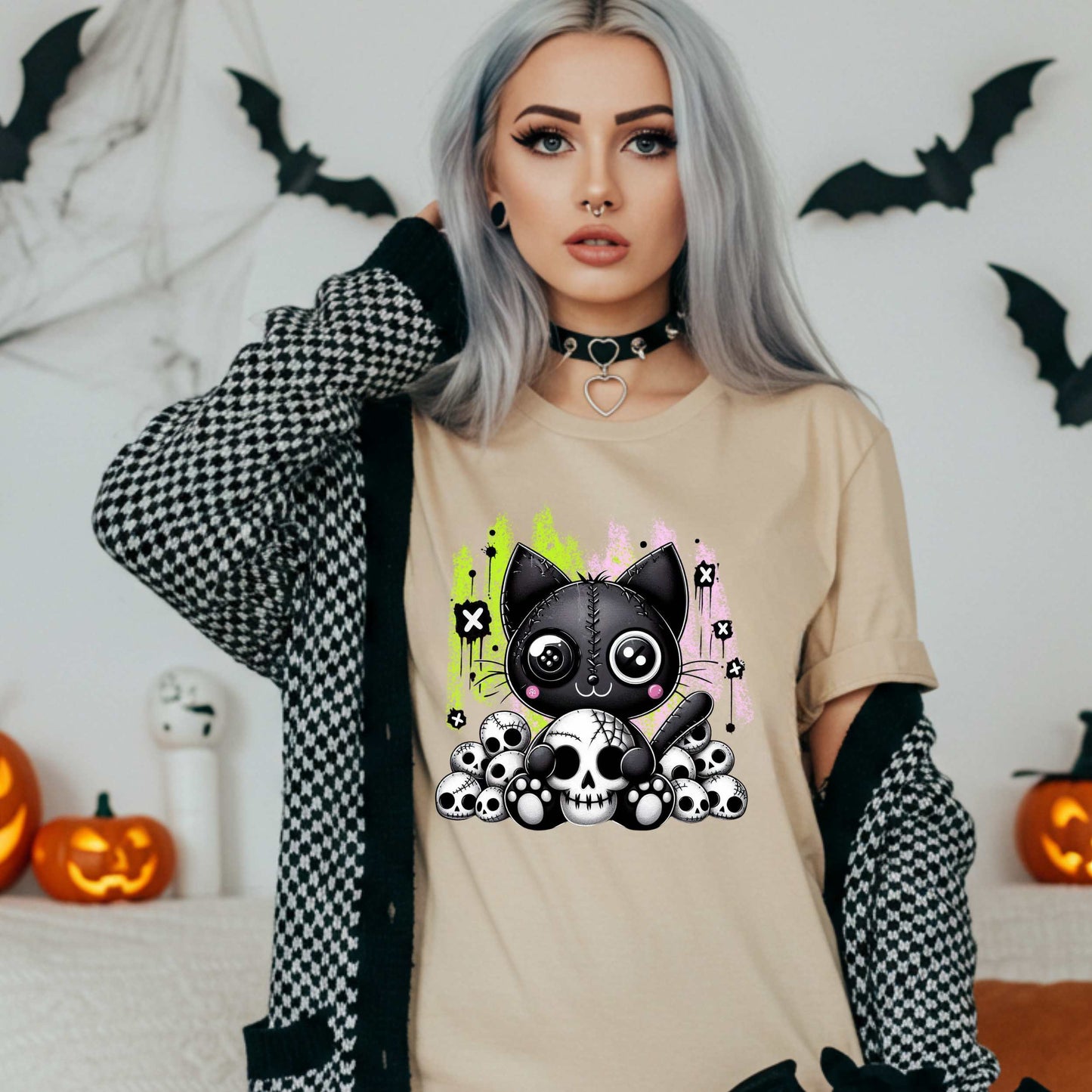 Pastel goth cat Halloween shirt for the spooky babe who wants to be cute, creepy, and slightly unbothered by your opinions. This little stitched-up kitten is sittin’ pretty on a pile of skulls, looking like she just clawed her way out of a haunted Lisa Frank binder. It’s soft, spooky, and a little sinister—just like your mood in October (and let’s be honest, year-round).&nbsp;