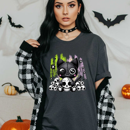 Pastel goth cat Halloween shirt for the spooky babe who wants to be cute, creepy, and slightly unbothered by your opinions. This little stitched-up kitten is sittin’ pretty on a pile of skulls, looking like she just clawed her way out of a haunted Lisa Frank binder. It’s soft, spooky, and a little sinister—just like your mood in October (and let’s be honest, year-round).&nbsp;