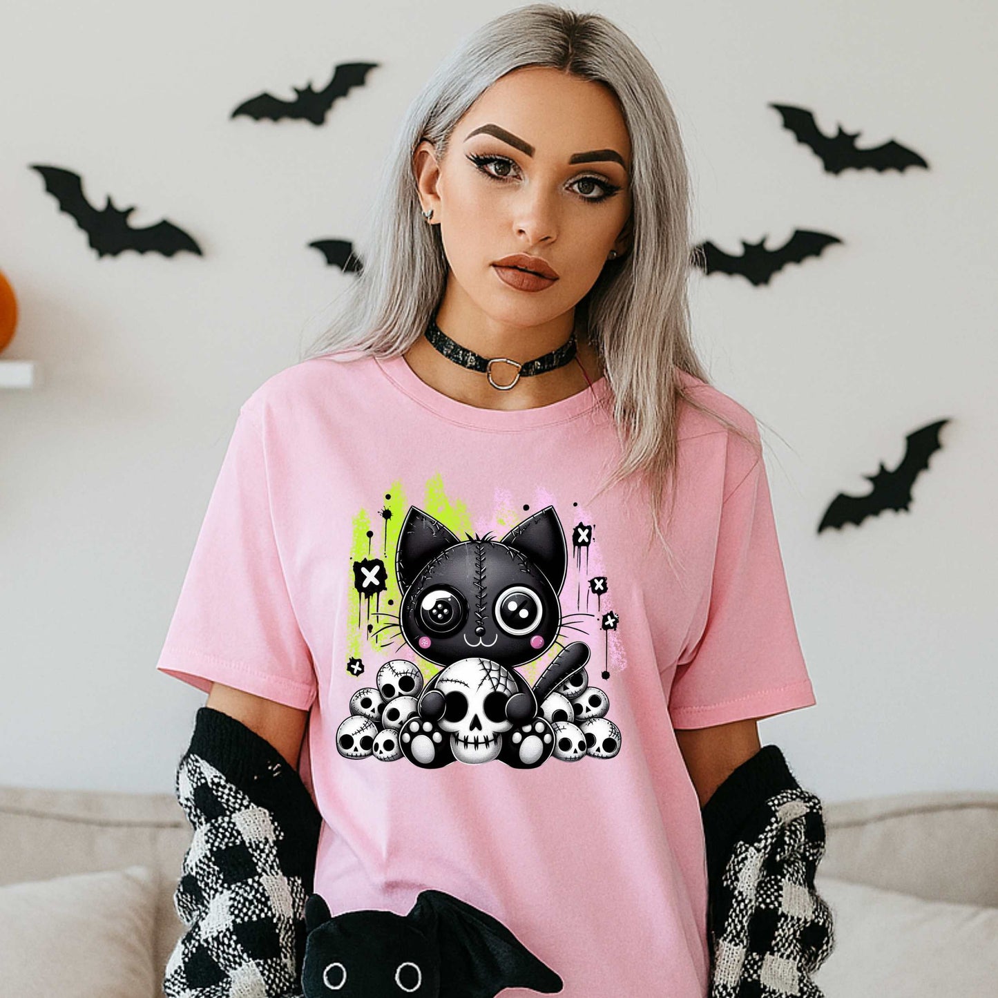 Pastel goth cat Halloween shirt for the spooky babe who wants to be cute, creepy, and slightly unbothered by your opinions. This little stitched-up kitten is sittin’ pretty on a pile of skulls, looking like she just clawed her way out of a haunted Lisa Frank binder. It’s soft, spooky, and a little sinister—just like your mood in October (and let’s be honest, year-round).&nbsp;