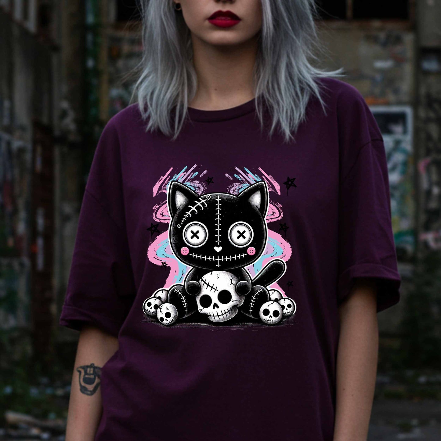This pastel goth cat Halloween shirt is what happens when adorable meets unhinged. Featuring a stitched-up button-eyed kitten chillin’ on a throne of skulls like it's just another Tuesday, this tee is made for the spooky soul with a soft side (and a slightly murderous glare). Wear it to haunt the streets or just vibe in your villain era—either way, it’s a look.&nbsp;