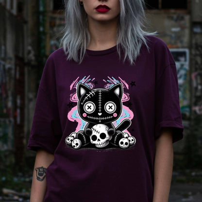 This pastel goth cat Halloween shirt is what happens when adorable meets unhinged. Featuring a stitched-up button-eyed kitten chillin’ on a throne of skulls like it's just another Tuesday, this tee is made for the spooky soul with a soft side (and a slightly murderous glare). Wear it to haunt the streets or just vibe in your villain era—either way, it’s a look.&nbsp;