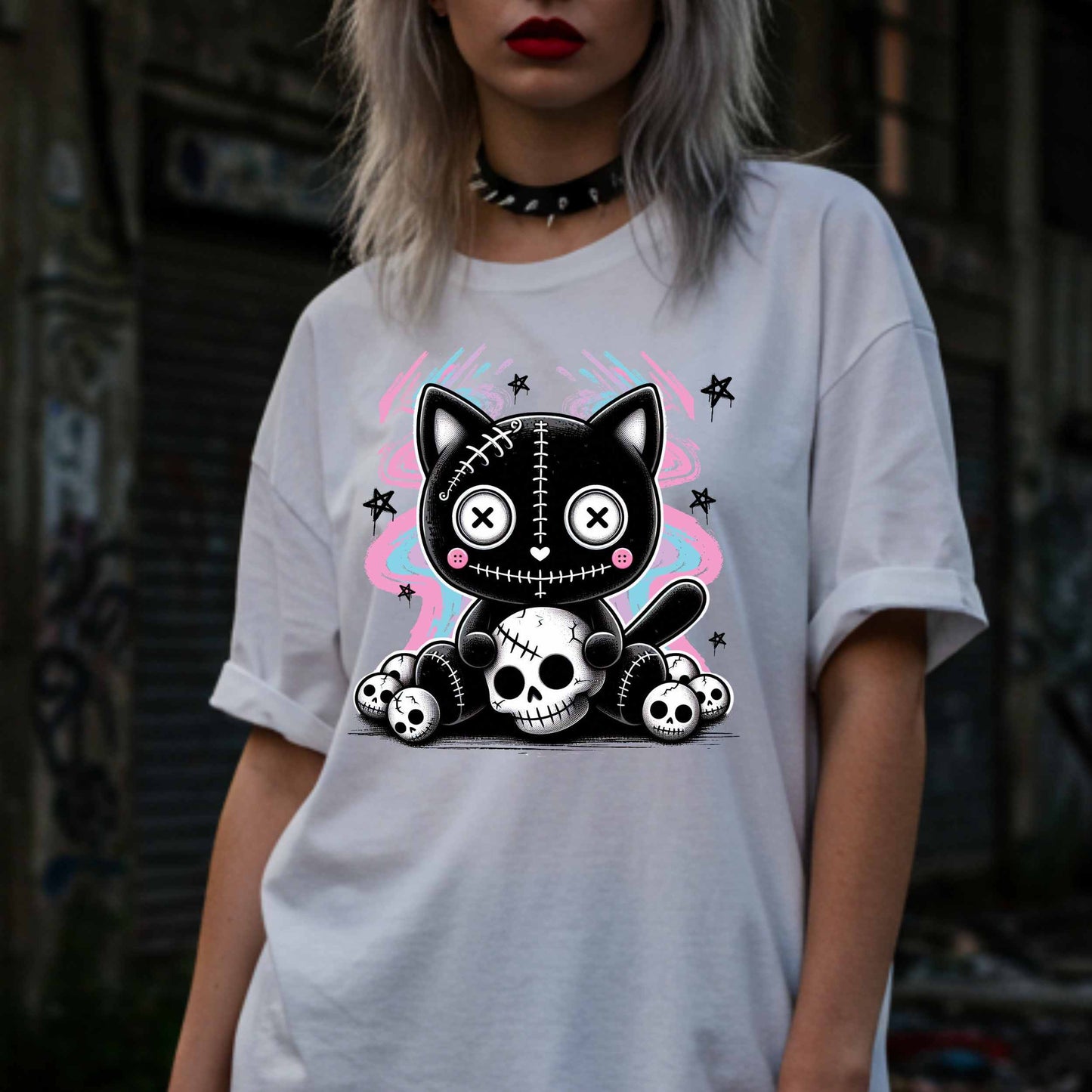 This pastel goth cat Halloween shirt is what happens when adorable meets unhinged. Featuring a stitched-up button-eyed kitten chillin’ on a throne of skulls like it's just another Tuesday, this tee is made for the spooky soul with a soft side (and a slightly murderous glare). Wear it to haunt the streets or just vibe in your villain era—either way, it’s a look.&nbsp;