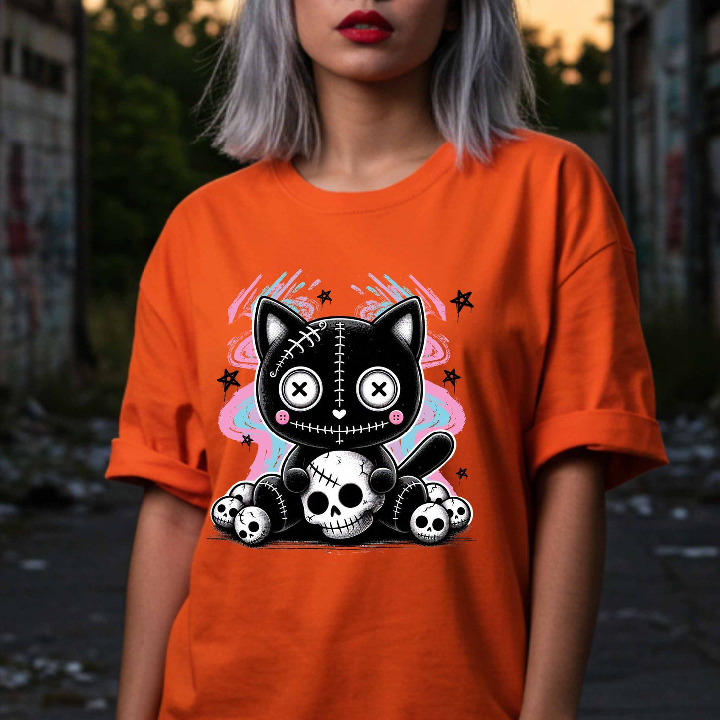 This pastel goth cat Halloween shirt is what happens when adorable meets unhinged. Featuring a stitched-up button-eyed kitten chillin’ on a throne of skulls like it's just another Tuesday, this tee is made for the spooky soul with a soft side (and a slightly murderous glare). Wear it to haunt the streets or just vibe in your villain era—either way, it’s a look.&nbsp;
