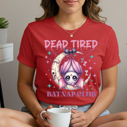 Dead tired and fully over it? Same. Join the Batnap Club with this pastel goth bat Halloween shirt, featuring a sleepy little winged gremlin who’s clearly clocked out. Wrapped in a pink bow and hanging like tomorrow’s problems, this adorable burnout bat is all of us in October (and every Monday). Perfect for spooky naps, haunted errands, or just surviving on caffeine and vibes.&nbsp;