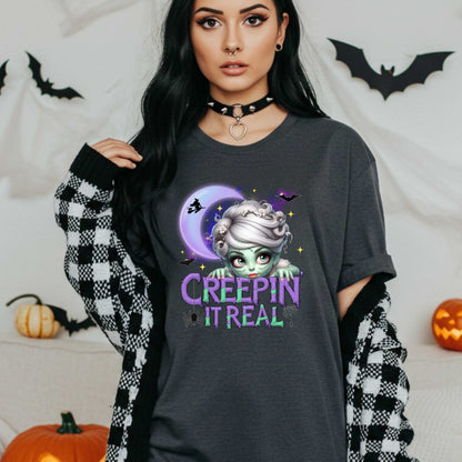This funny Creepin’ It Real Halloween shirt is the perfect spooky tee for keeping it creepy, cute, and a little unhinged all spooky season long. Who needs subtle when you can be bold, undead, and sarcastically stylish? Whether you're haunting the living room or creeping through the Halloween party like a glam ghoul, this cute creepy graphic tee is a whole October mood. 