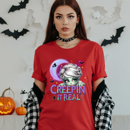 This funny Creepin’ It Real Halloween shirt is the perfect spooky tee for keeping it creepy, cute, and a little unhinged all spooky season long. Who needs subtle when you can be bold, undead, and sarcastically stylish? Whether you're haunting the living room or creeping through the Halloween party like a glam ghoul, this cute creepy graphic tee is a whole October mood. 