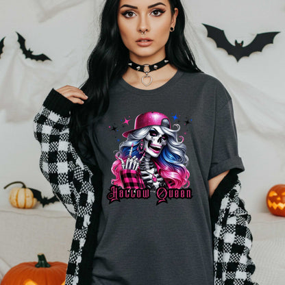 Featuring a glam skeleton with flowing pastel hair, pink flannel, and a glittery hat, she’s clearly been slaying the afterlife runway since 1802. Perfect for the girls who haunt with heels, sparkle under the moonlight, and don’t have time for basic. Serve full-body sass while you sashay through spooky season.