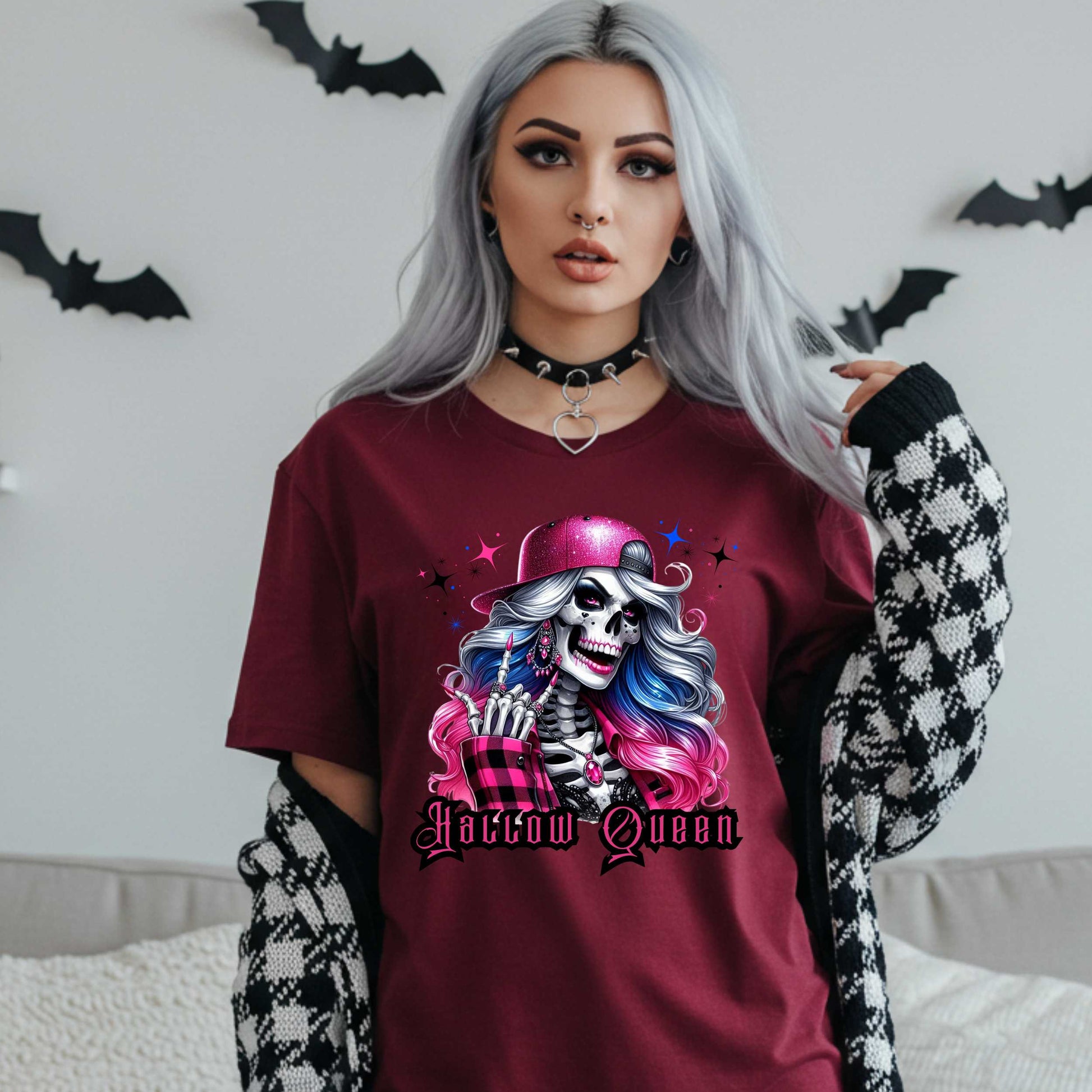 Featuring a glam skeleton with flowing pastel hair, pink flannel, and a glittery hat, she’s clearly been slaying the afterlife runway since 1802. Perfect for the girls who haunt with heels, sparkle under the moonlight, and don’t have time for basic. Serve full-body sass while you sashay through spooky season.