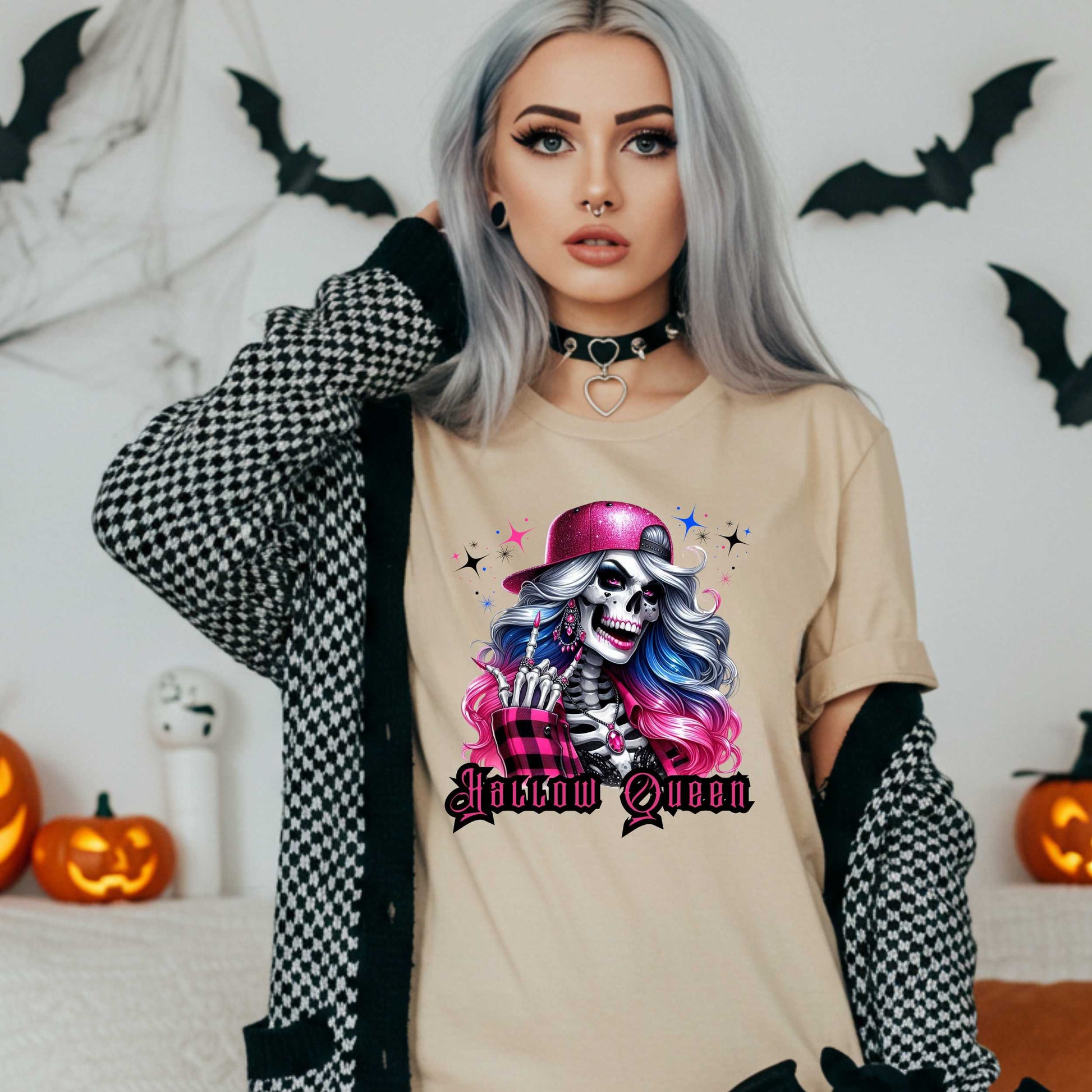 Featuring a glam skeleton with flowing pastel hair, pink flannel, and a glittery hat, she’s clearly been slaying the afterlife runway since 1802. Perfect for the girls who haunt with heels, sparkle under the moonlight, and don’t have time for basic. Serve full-body sass while you sashay through spooky season.