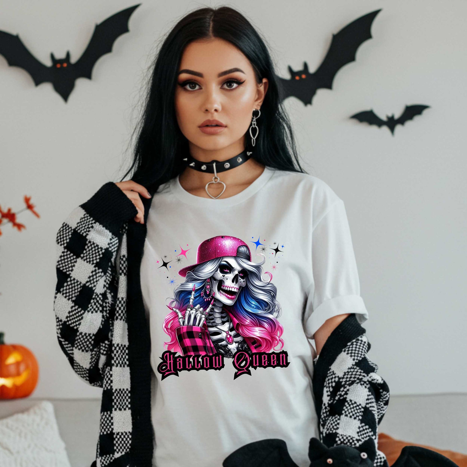 Featuring a glam skeleton with flowing pastel hair, pink flannel, and a glittery hat, she’s clearly been slaying the afterlife runway since 1802. Perfect for the girls who haunt with heels, sparkle under the moonlight, and don’t have time for basic. Serve full-body sass while you sashay through spooky season.