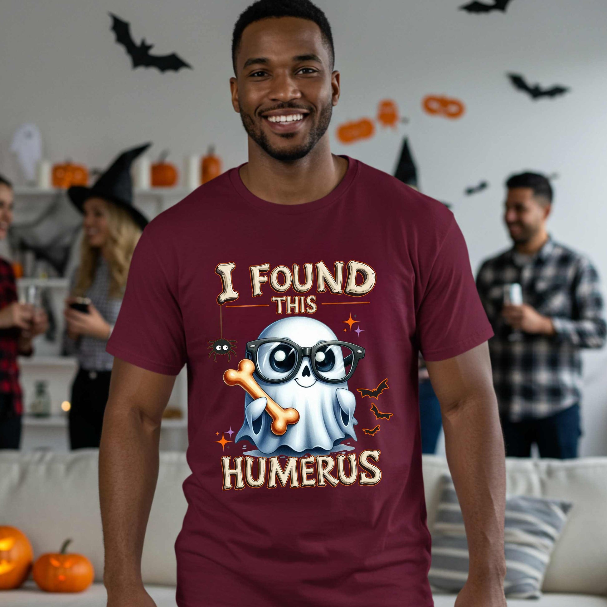 Bone-afide hilarious. This “I Found This Humerus” tee is the ultimate Halloween dad joke wrapped in spooky cute style. Featuring a ghost rocking nerdy glasses and proudly holding a humerus bone like it just cracked itself up—because it did. 