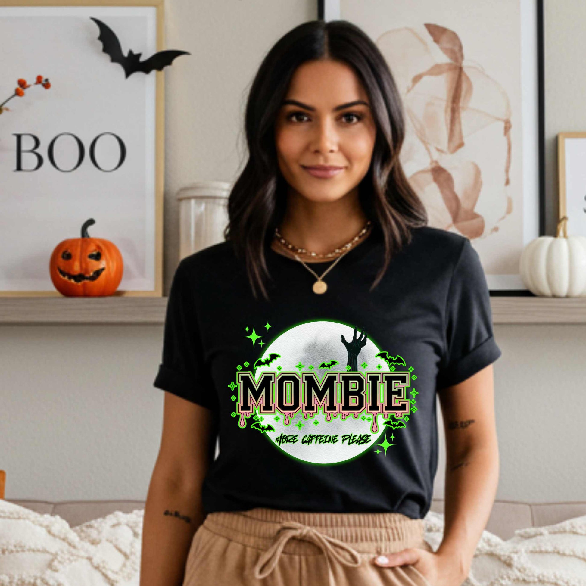 This hilariously relatable Halloween tee is perfect for the spooky season (and honestly, every Monday). With a ghoulish hand rising for coffee and the plea “More Caffeine Please,” this shirt speaks fluent mom and monster. Whether you're chasing kids or caffeine, this tee is your ultimate uniform for the undead-but-still-doing-it life.
