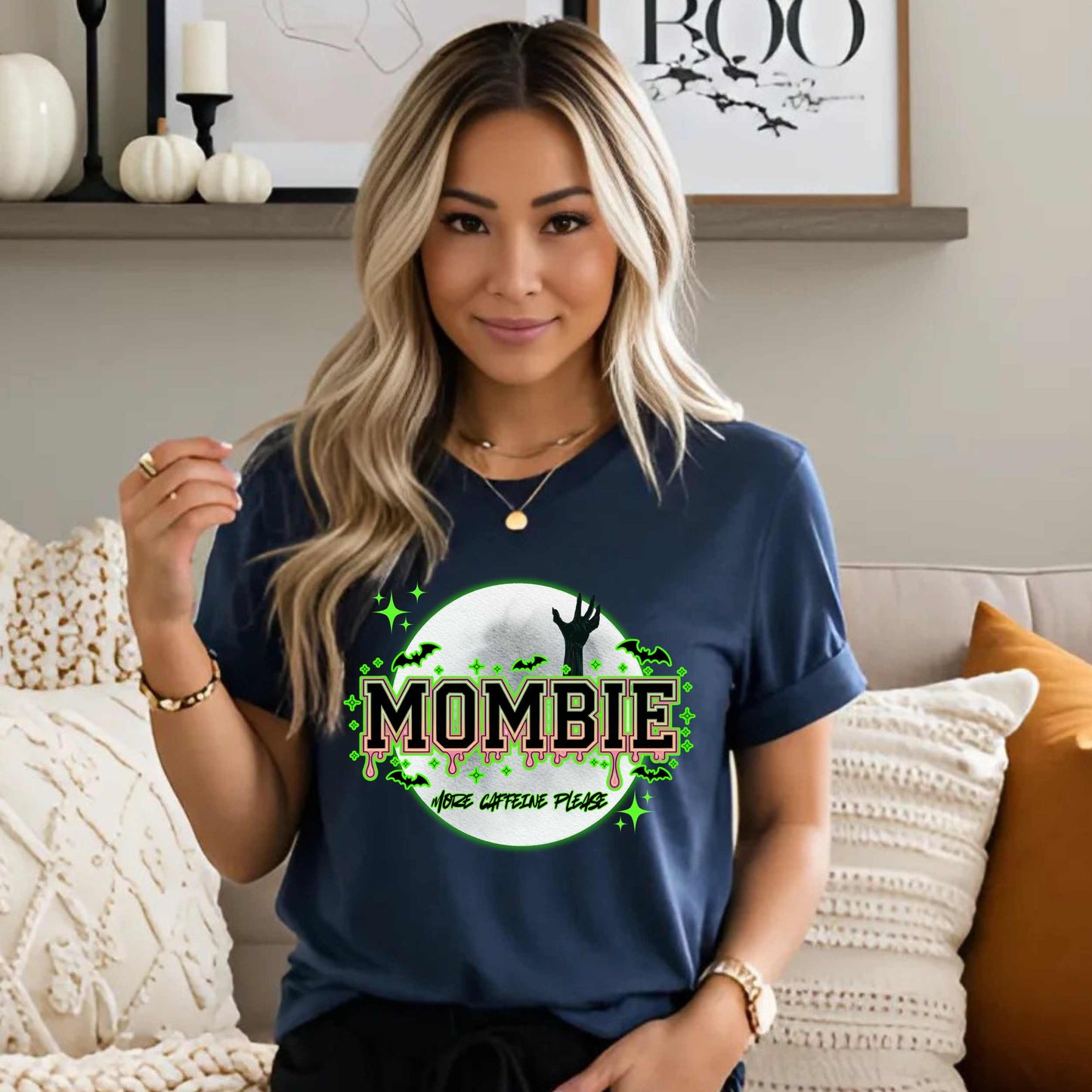 This hilariously relatable Halloween tee is perfect for the spooky season (and honestly, every Monday). With a ghoulish hand rising for coffee and the plea “More Caffeine Please,” this shirt speaks fluent mom and monster. Whether you're chasing kids or caffeine, this tee is your ultimate uniform for the undead-but-still-doing-it life.
