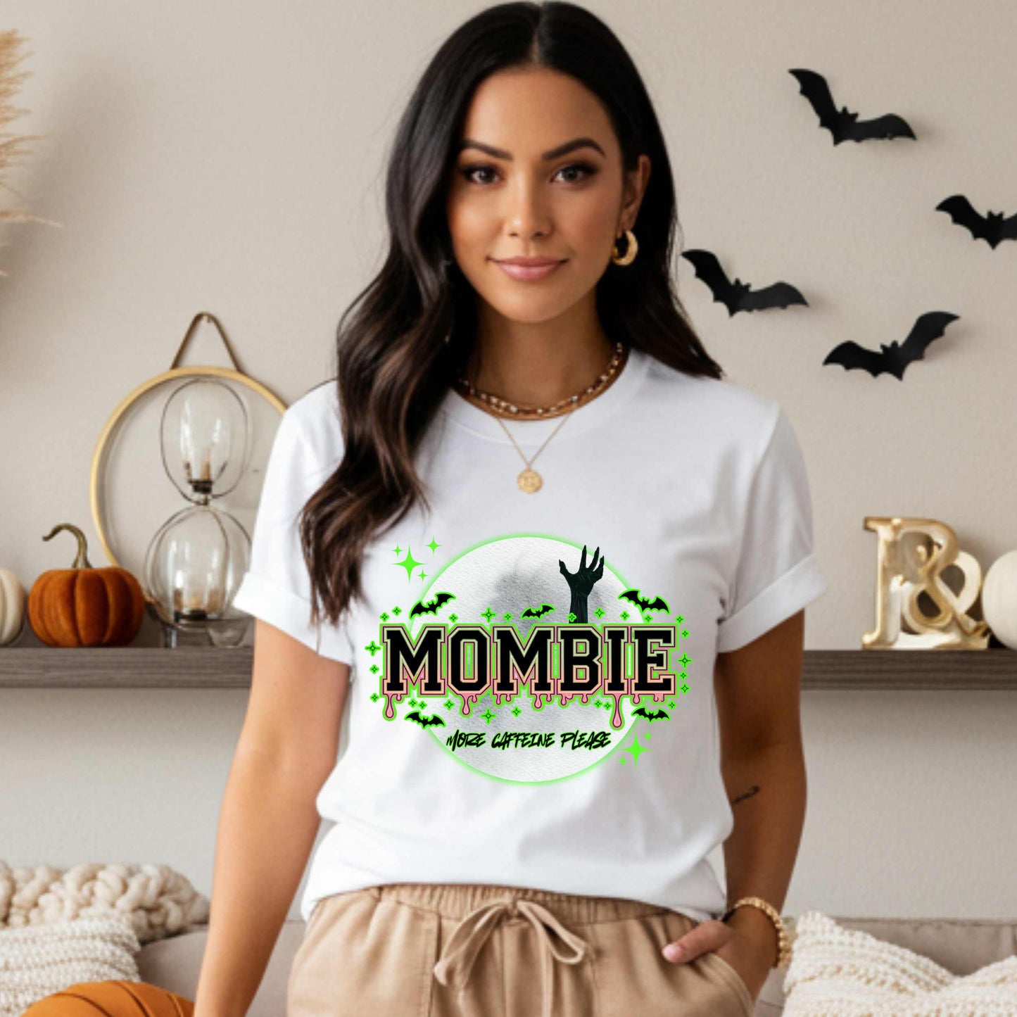 This hilariously relatable Halloween tee is perfect for the spooky season (and honestly, every Monday). With a ghoulish hand rising for coffee and the plea “More Caffeine Please,” this shirt speaks fluent mom and monster. Whether you're chasing kids or caffeine, this tee is your ultimate uniform for the undead-but-still-doing-it life.