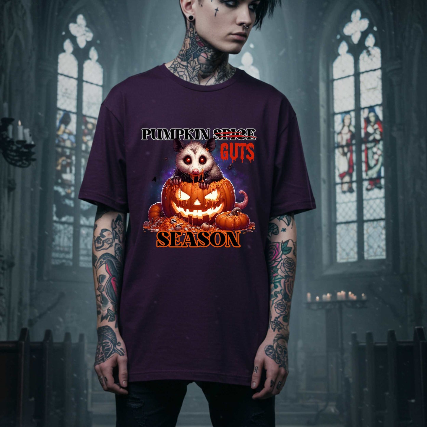 his shirt is for the spooky souls who prefer chaos over cinnamon and guts over glitter. Featuring a bug-eyed opossum with serial killer energy and a face full of pumpkin guts, this tee is perfect for anyone who thinks PSLs are for basic witches and wants to haunt fall fashion in the most unhinged way possible.