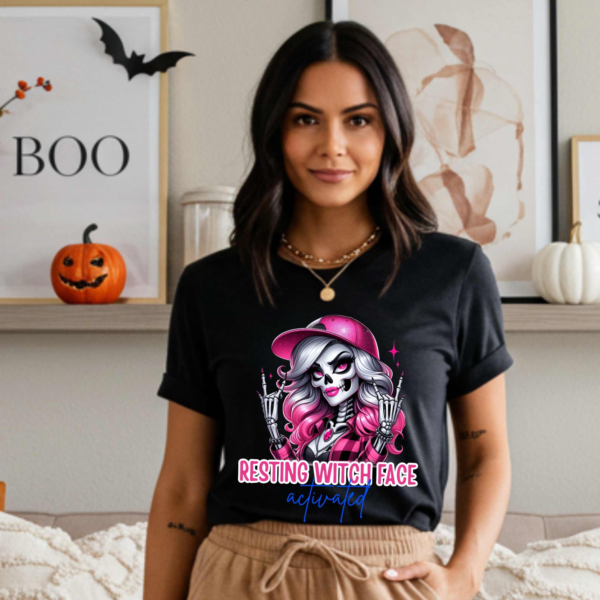 Warning: Resting Witch Face Activated. This glam skeleton came back from the dead just to not deal with your nonsense. With flawless pink curls, a sparkly cap, and that iconic “don’t test me” stare, this tee is giving spooky sass in full effect. Perfect for ghouls who slay silently, serve looks with zero expression, and ghost negativity on sight.