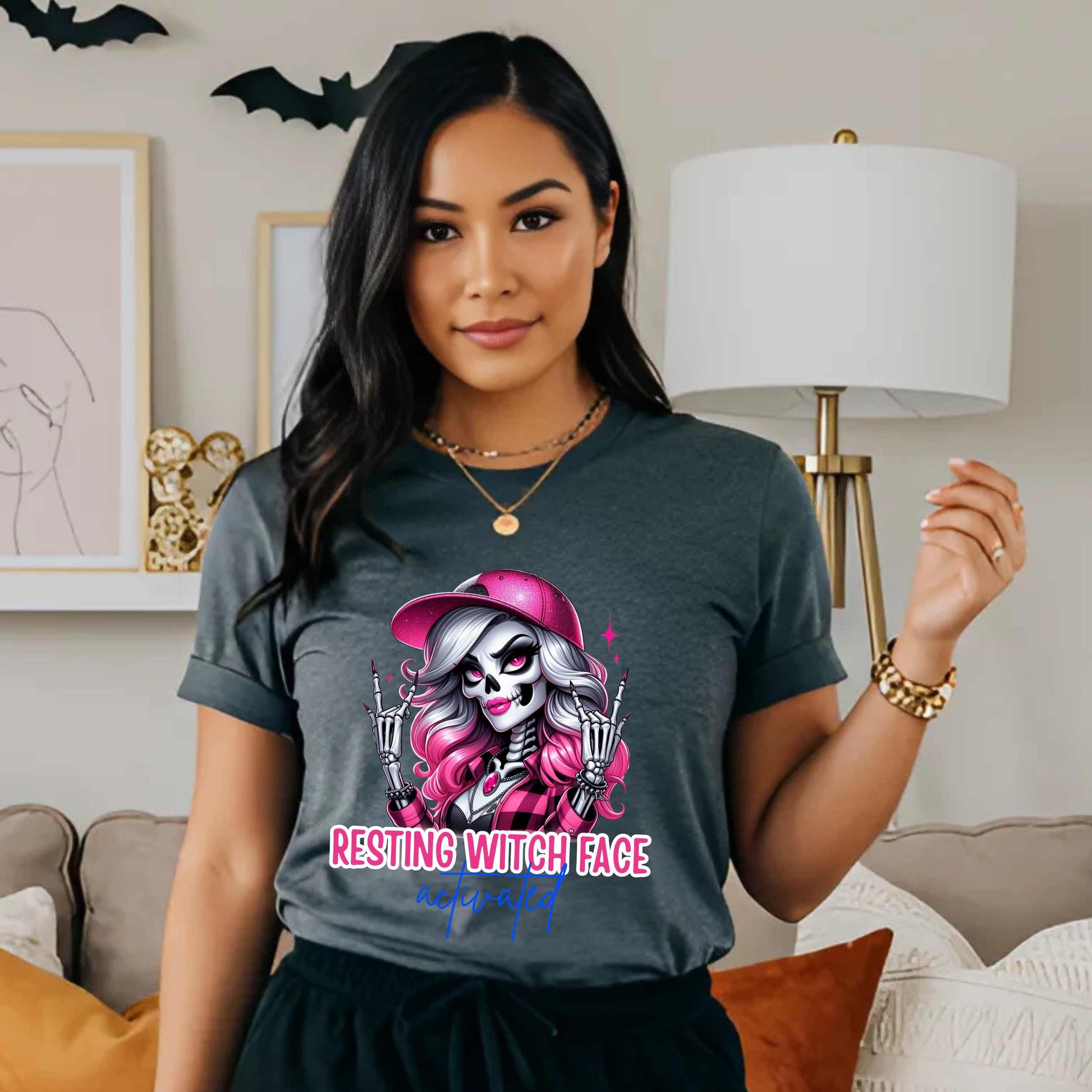 Warning: Resting Witch Face Activated. This glam skeleton came back from the dead just to not deal with your nonsense. With flawless pink curls, a sparkly cap, and that iconic “don’t test me” stare, this tee is giving spooky sass in full effect. Perfect for ghouls who slay silently, serve looks with zero expression, and ghost negativity on sight.