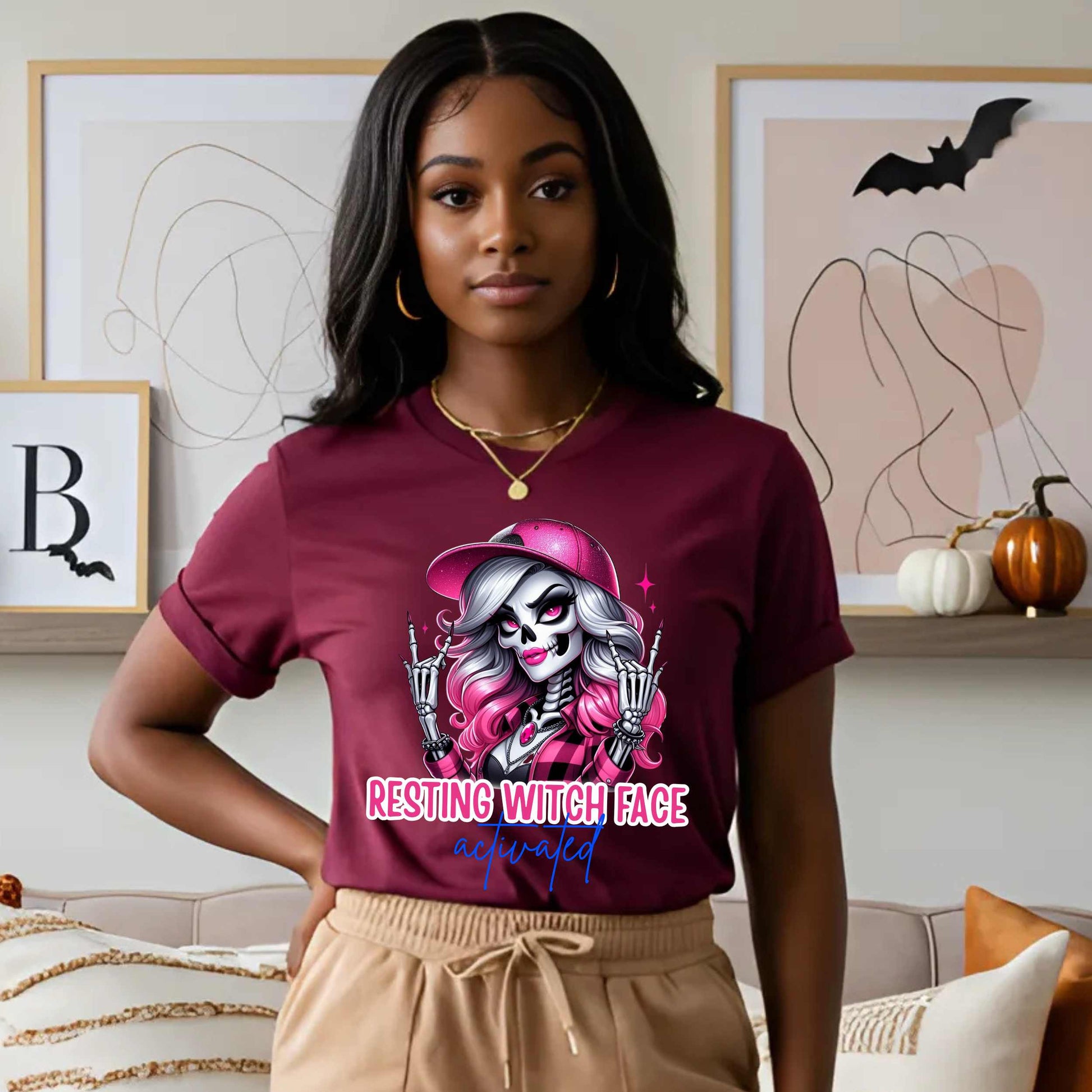Warning: Resting Witch Face Activated. This glam skeleton came back from the dead just to not deal with your nonsense. With flawless pink curls, a sparkly cap, and that iconic “don’t test me” stare, this tee is giving spooky sass in full effect. Perfect for ghouls who slay silently, serve looks with zero expression, and ghost negativity on sight.