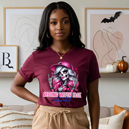 Warning: Resting Witch Face Activated. This glam skeleton came back from the dead just to not deal with your nonsense. With flawless pink curls, a sparkly cap, and that iconic “don’t test me” stare, this tee is giving spooky sass in full effect. Perfect for ghouls who slay silently, serve looks with zero expression, and ghost negativity on sight.