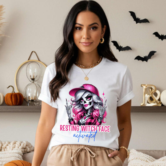 Warning: Resting Witch Face Activated. This glam skeleton came back from the dead just to not deal with your nonsense. With flawless pink curls, a sparkly cap, and that iconic “don’t test me” stare, this tee is giving spooky sass in full effect. Perfect for ghouls who slay silently, serve looks with zero expression, and ghost negativity on sight.