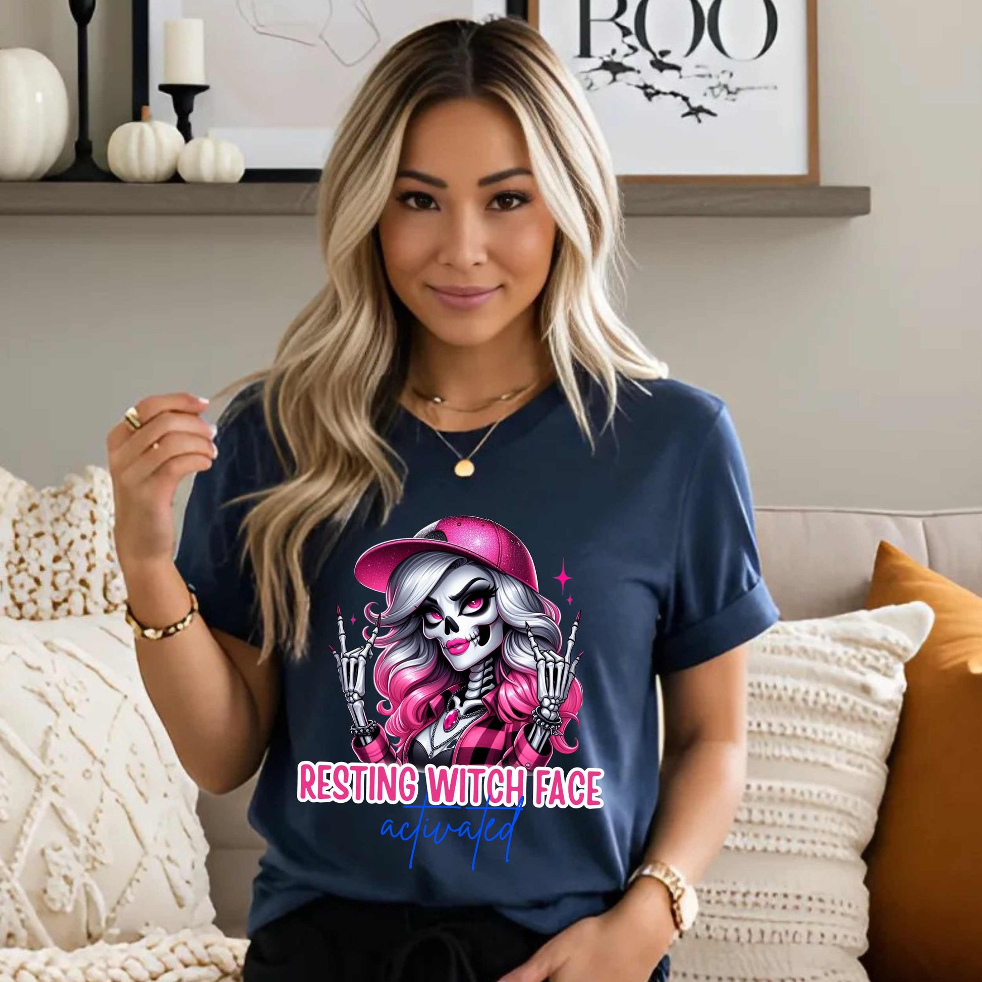 Warning: Resting Witch Face Activated. This glam skeleton came back from the dead just to not deal with your nonsense. With flawless pink curls, a sparkly cap, and that iconic “don’t test me” stare, this tee is giving spooky sass in full effect. Perfect for ghouls who slay silently, serve looks with zero expression, and ghost negativity on sight.