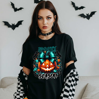 Step aside basic witches, this pumpkin came to SLAY. Our Spooky Season tee brings the perfect mix of creepy and cute—featuring a fierce jack-o’-lantern crowned with a bold teal bow and surrounded by gothic glam accents.