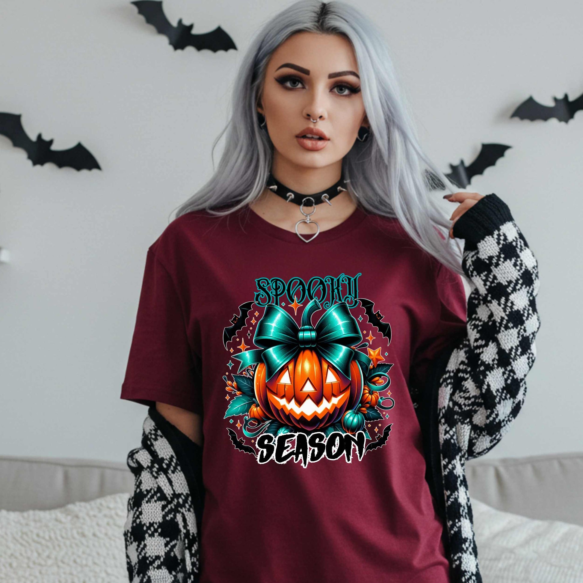 Step aside basic witches, this pumpkin came to SLAY. Our Spooky Season tee brings the perfect mix of creepy and cute—featuring a fierce jack-o’-lantern crowned with a bold teal bow and surrounded by gothic glam accents.