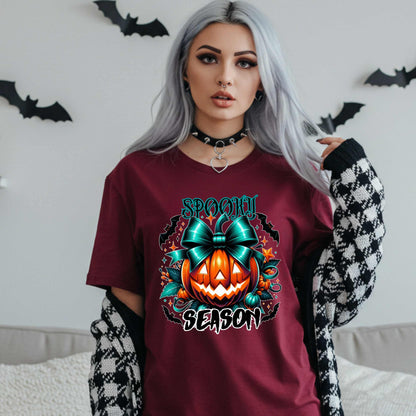 Step aside basic witches, this pumpkin came to SLAY. Our Spooky Season tee brings the perfect mix of creepy and cute—featuring a fierce jack-o’-lantern crowned with a bold teal bow and surrounded by gothic glam accents.