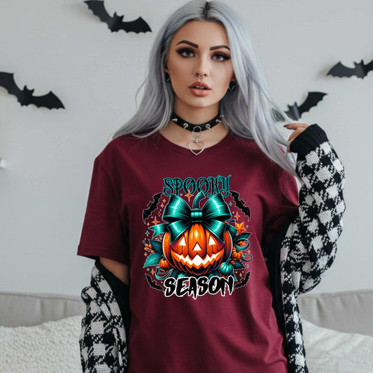 Step aside basic witches, this pumpkin came to SLAY. Our Spooky Season tee brings the perfect mix of creepy and cute—featuring a fierce jack-o’-lantern crowned with a bold teal bow and surrounded by gothic glam accents.
