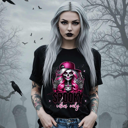  This Spooky Vibes Only tee is the perfect blend of glam and goth, featuring a pink-haired skeleton baddie with nails sharp enough to slash a pumpkin and a hat tilted like she’s haunting the runway. This shirt is for the ghouls who don’t do basic. 