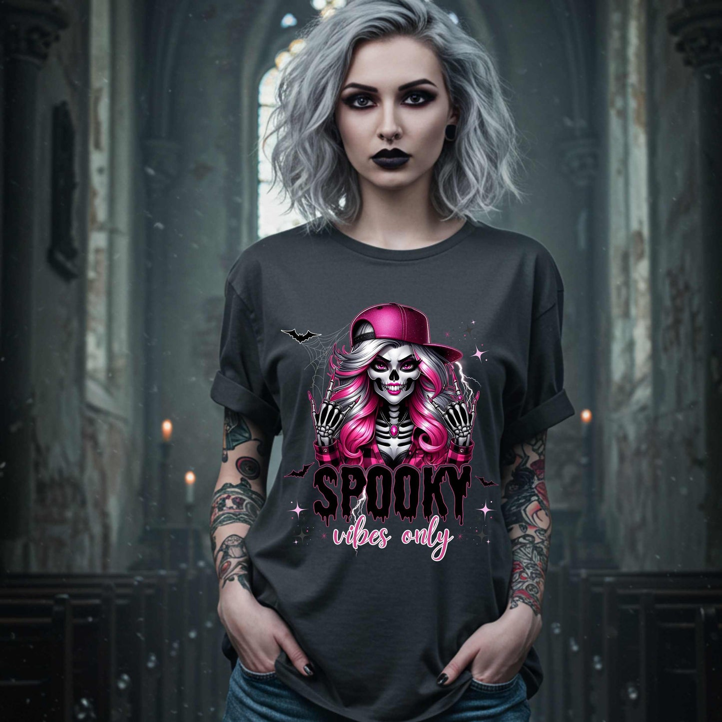  This Spooky Vibes Only tee is the perfect blend of glam and goth, featuring a pink-haired skeleton baddie with nails sharp enough to slash a pumpkin and a hat tilted like she’s haunting the runway. This shirt is for the ghouls who don’t do basic. 